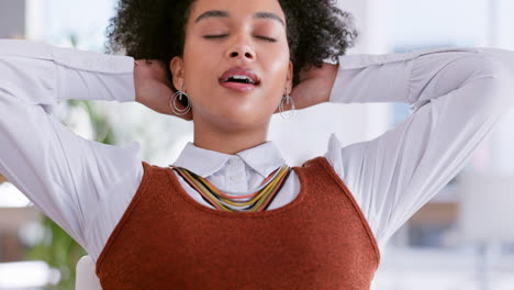 Happy-woman-on-laptop-stretching-at-her-desk