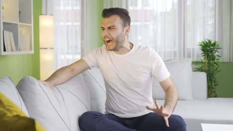 major depressed young man angry and unhappy at home.