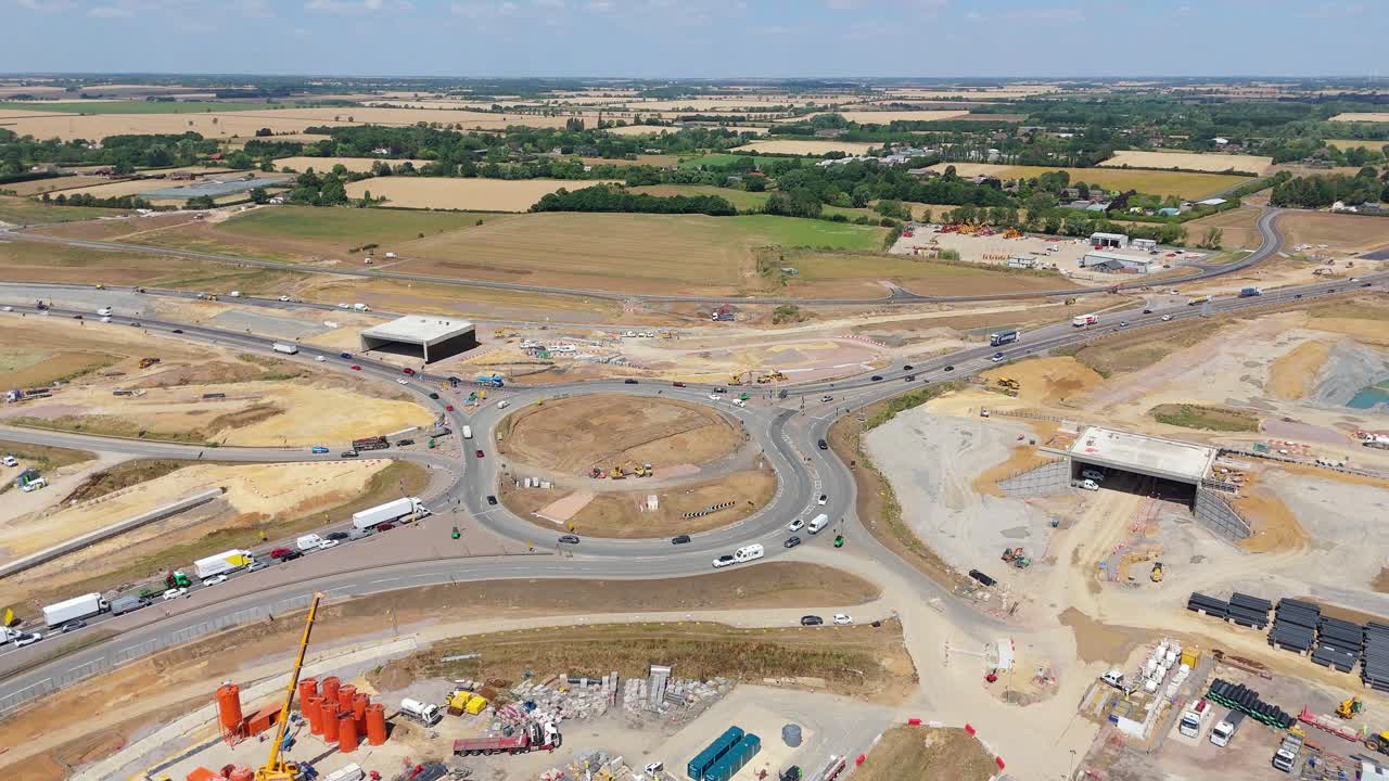 Drone flyover showing roadworks at Black Cat Roundabout Bedfordshire with diggers, trucks, and vehicles