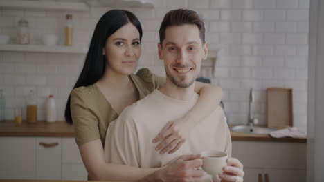 happy couple enjoying coffee in the kitchen