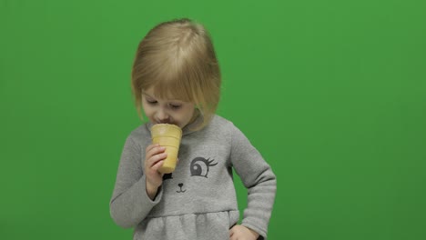 kid girl eat ice cream on a green screen, chroma key