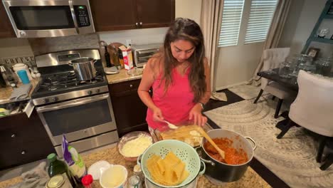 italian woman making homemade lasagna with layered ricotta cheese