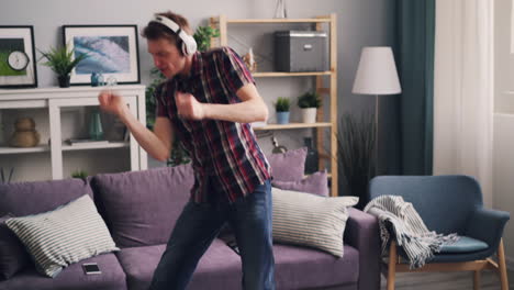 man dancing at home with headphones