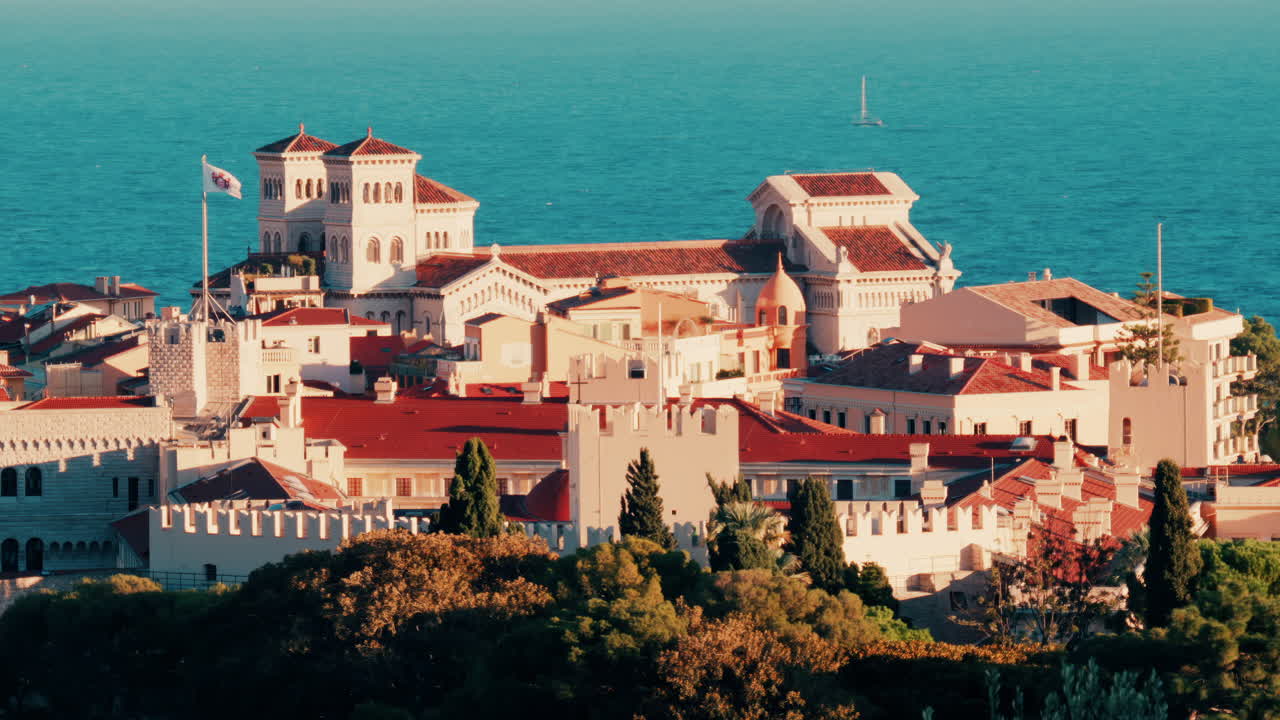 Distant aerial view of the Prince's Palace in the skyline of Monaco with the sea on the background