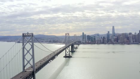 aerial: cityscape and a bridge by the sea, drone view