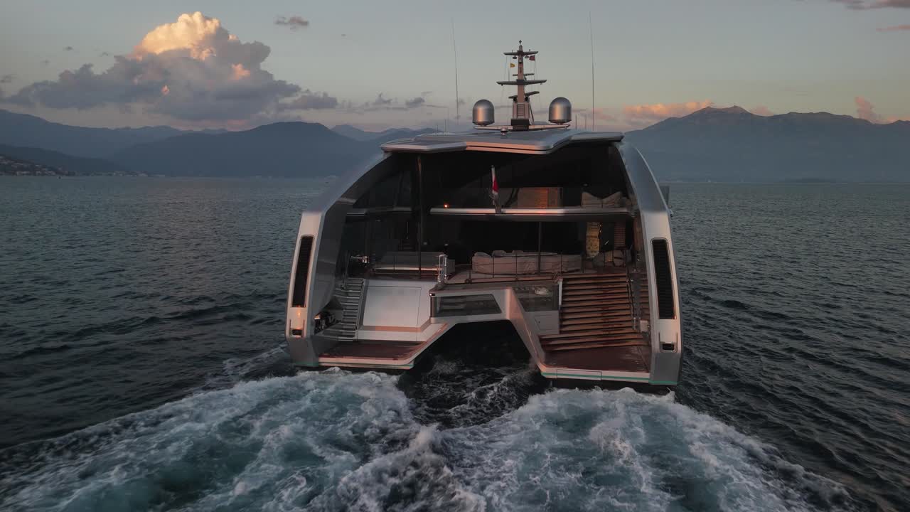 Low aerial shows classy design of unique catamaran motor yacht on sea