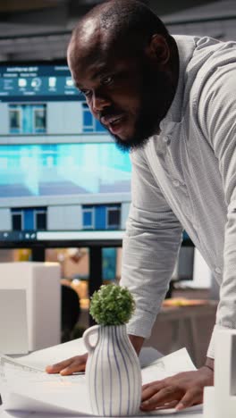 vertical video black real estate developer does city planning with architectural sketch