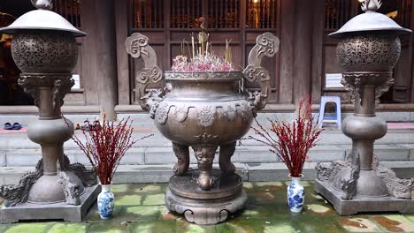 a serene temple courtyard with incense burners