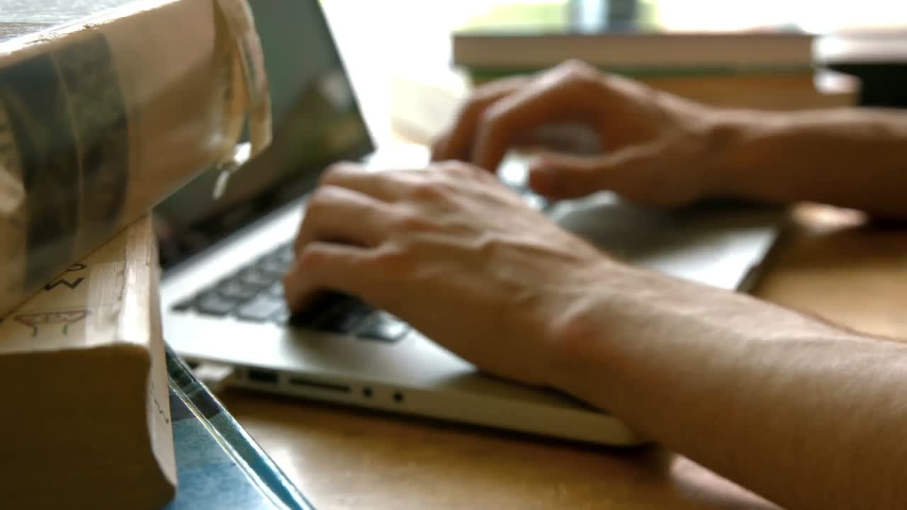 Student typing away on a laptop
