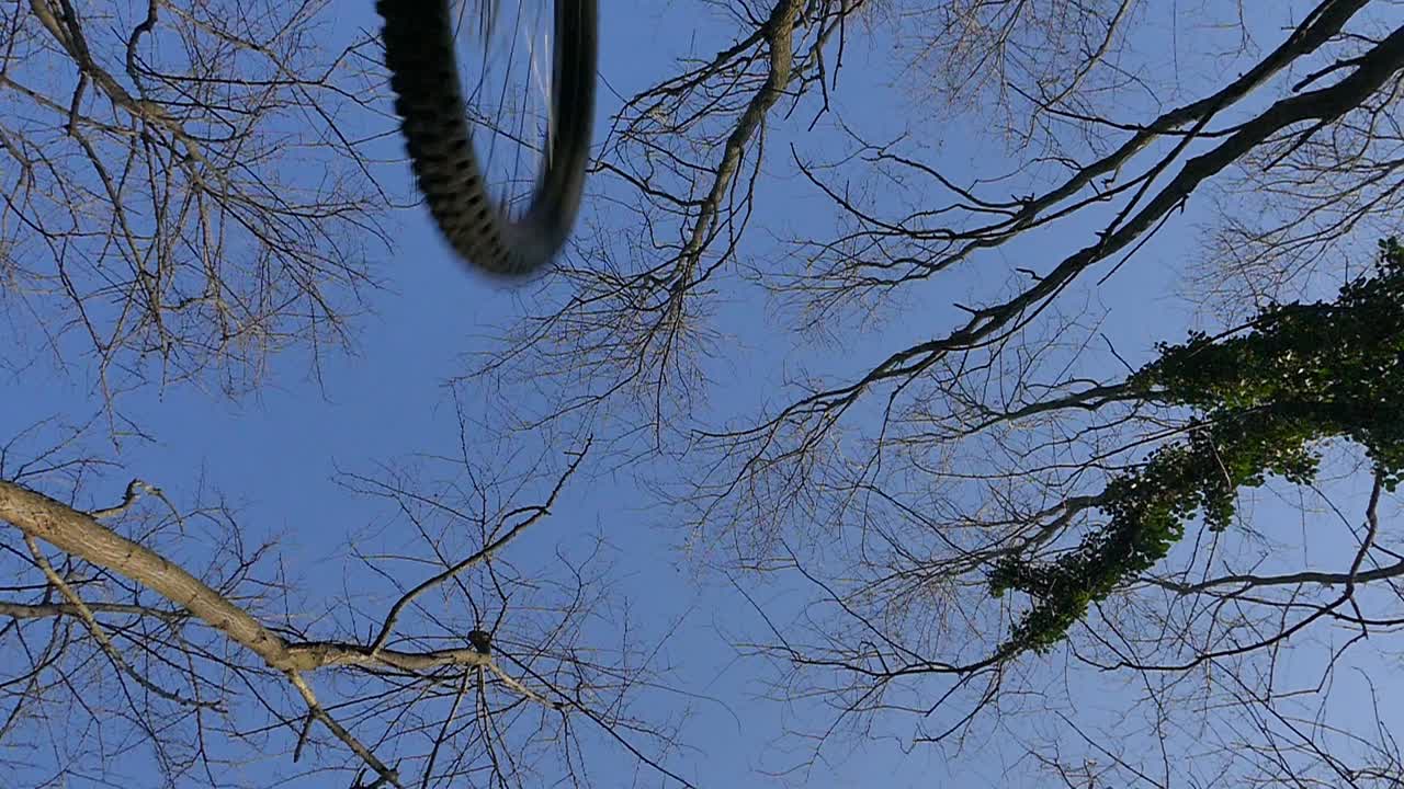 MTB Jump shot from below the bike (rider jumps above camera)