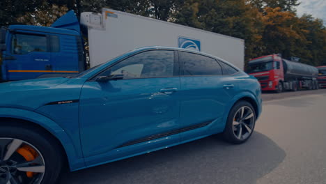 electric metallic blue audi e-tron 55 quattro suv. audi e tron, a fully electric car on highway