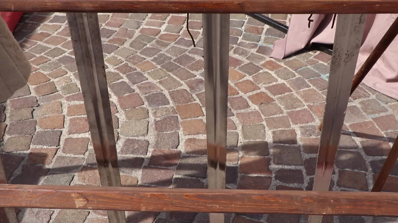 Tilt shot of medieval swords exposed on a wooden rack at a historical festival