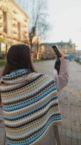 woman taking a video call on a city street