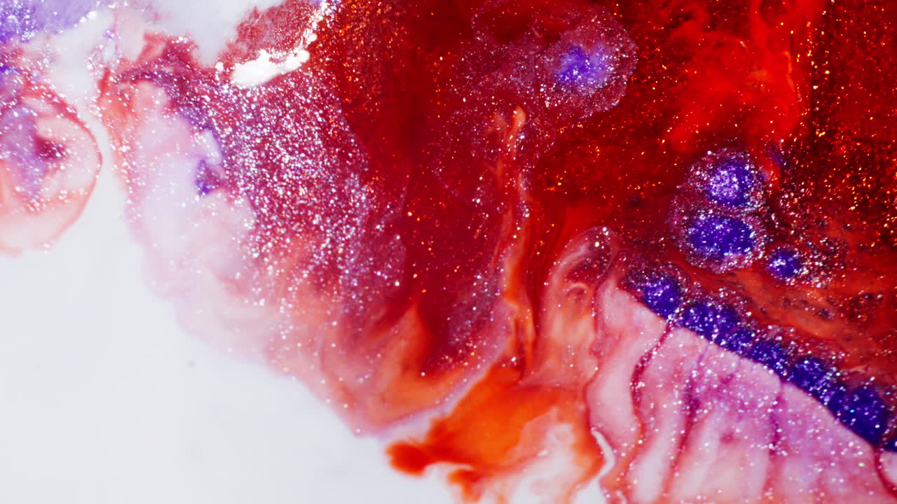 Red, Orange And Blue Ink With Glitter Forming Fractals On A White Background. - abstract