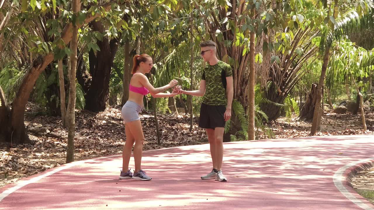 Couple Stretching Outdoors in Park