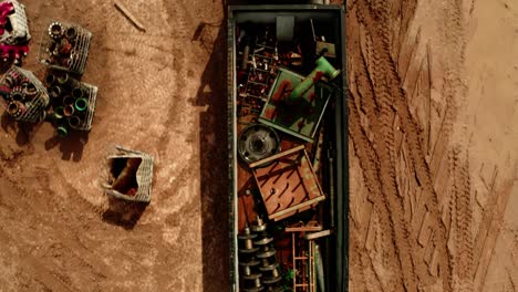 top down view of scrap metal truck driving through a dirt yard