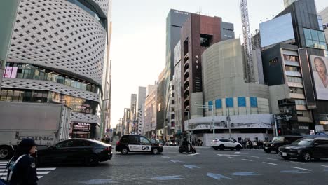 traffic and pedestrians at a busy city crosswalk