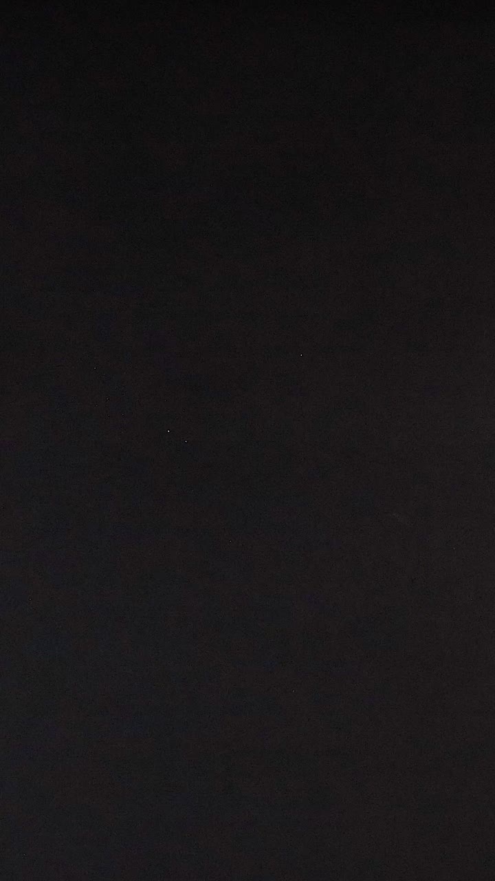 Ping pong ball rolls across a dark surface