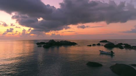 beautiful sunset over the ocean with a small boat