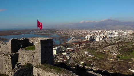 albanian flag on stone walls of ancient fortress of rozafa in shkodra, albania