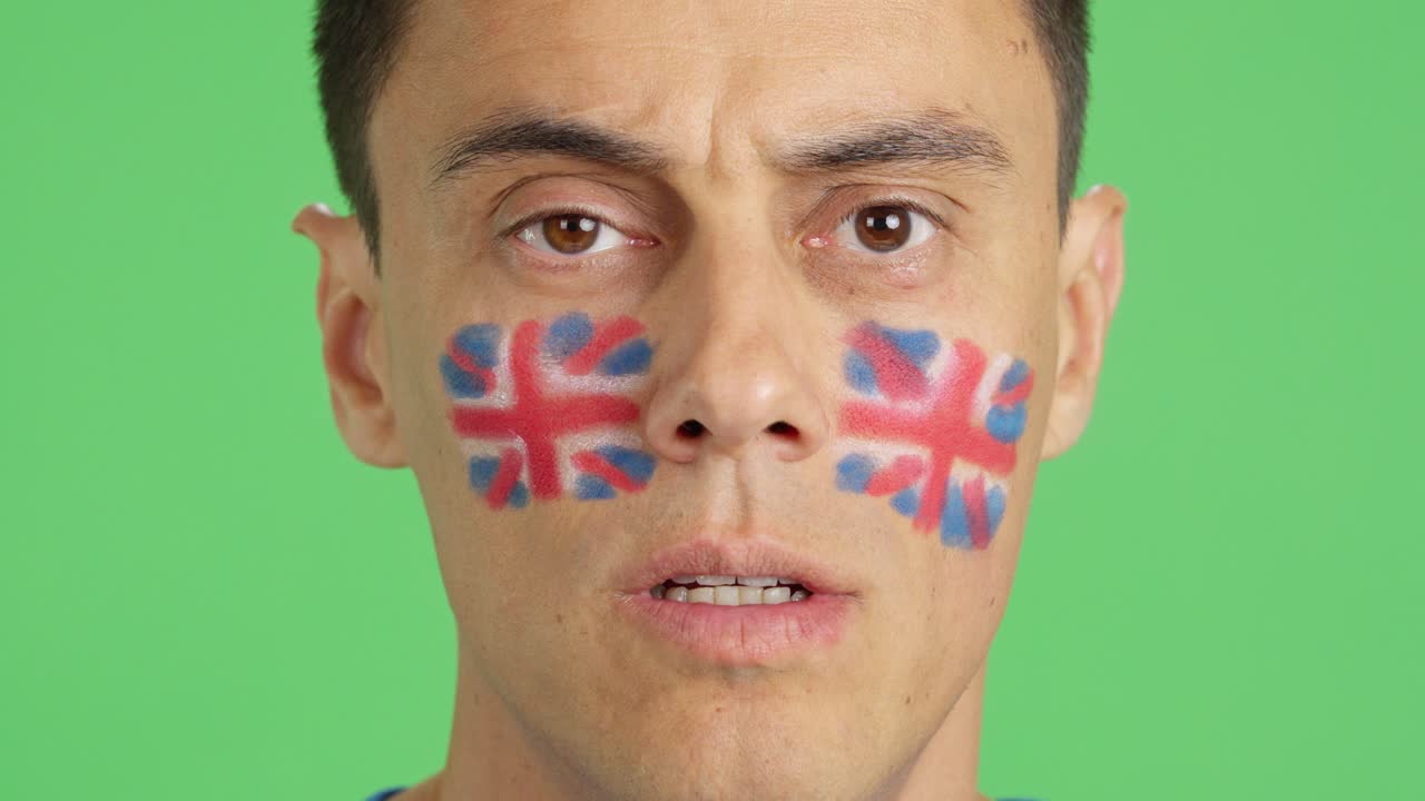Man with a british flag painted on the face smiling