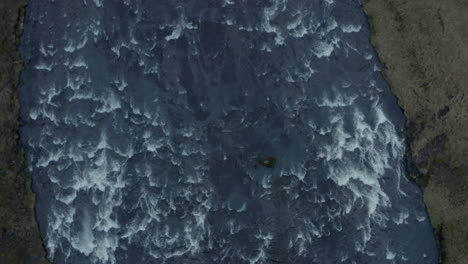 Top-down-aerial-shot-looking-down-Skógafoss-waterfall-Iceland