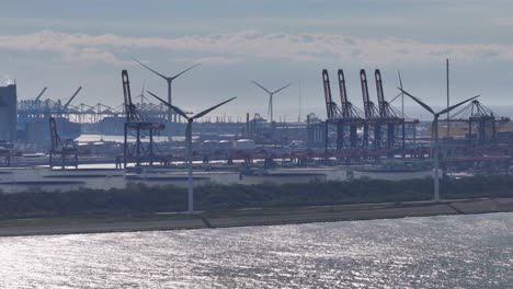 the wind turbines located at the euromax terminal within the port of rotterdam in the netherlands - wide shot