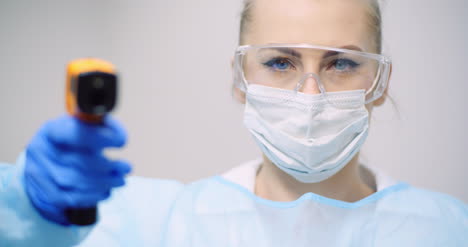 doctor measuring patient temperature at health care clinic 4