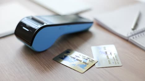 payment terminal and credit cards on a desk