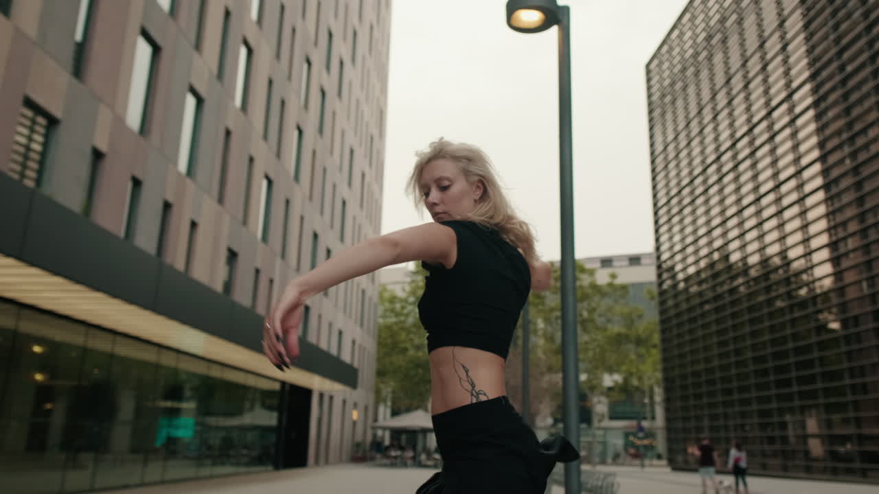 Young Woman Performing Expressive Dance in Urban Setting