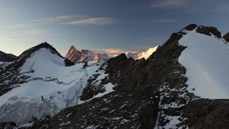 Aerial-shot-flying-sideways-to-the-left,-revealing-the-ice-and-snow-covered-glacier-in-near-Gleckstein-Hut-in-Switzerland