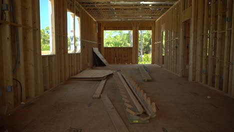 revealing shot of a pair of wooden staircase stringer on the floor of house being constructed