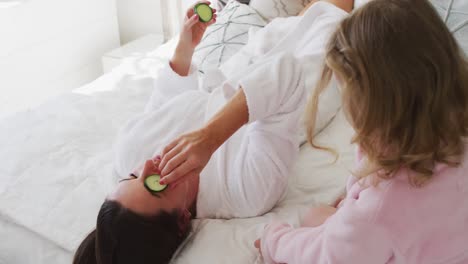 Caucasian-mother-and-daughter-having-fun-relaxing-in-bedroom