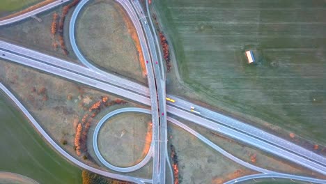 aerial view of freeway intersection with moving traffic cars