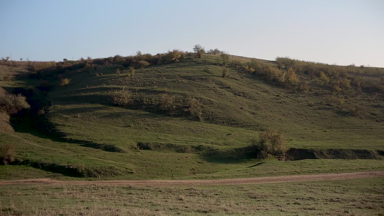 Looking at the green hills of the countryside -wide pan
