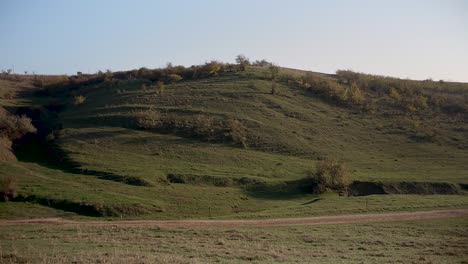 looking at the green hills of the countryside -wide pan