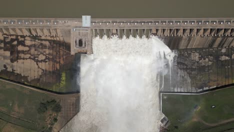 bird's eye view of power dam releasing water during spring flooding