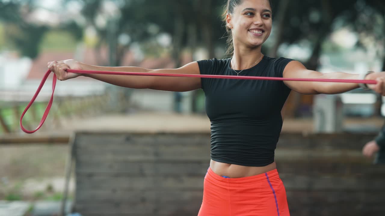 Woman exercising with resistance band outdoors