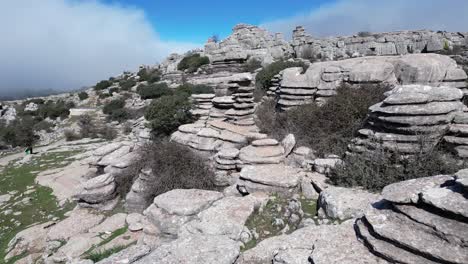 Flying-with-a-drone-through-the-natural-area-of-​​El-Torcal,-a-karst-area-located-in-Antequera-in-the-province-of-Malaga,-Spain