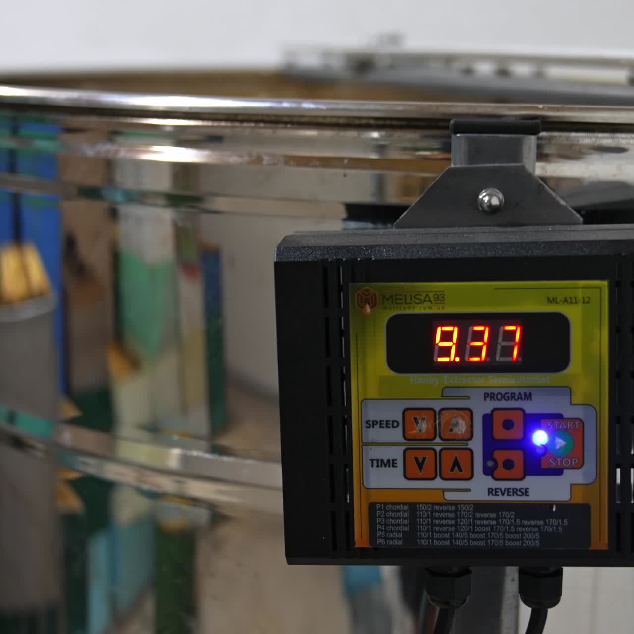 Sensor working on the electric machine for honey extraction. Close up. Equipment for pumping honey in the process of work