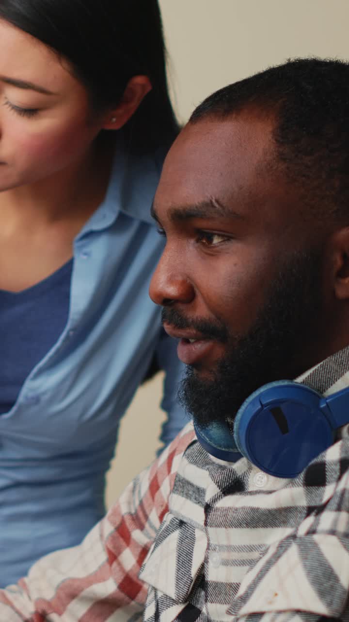 Vertical video: Diverse team of videographers working on movie footage edit