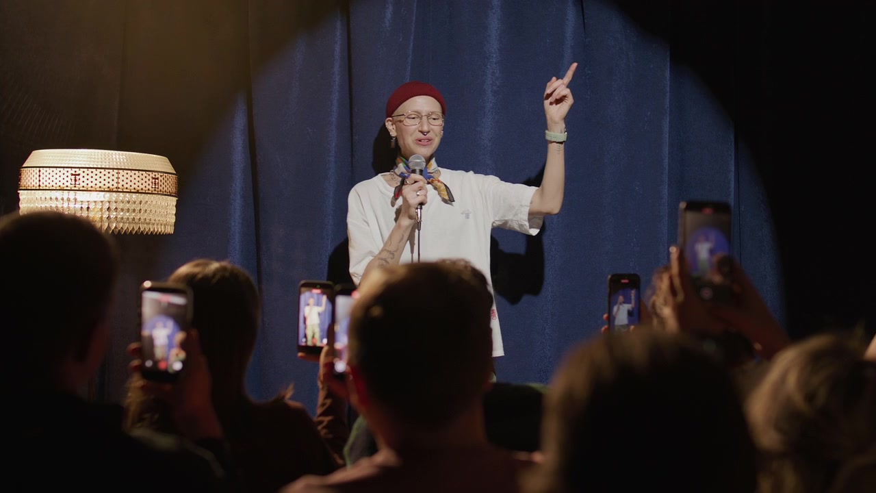 Comedian Performing during Stand Up Show while Audience Filming with Phones