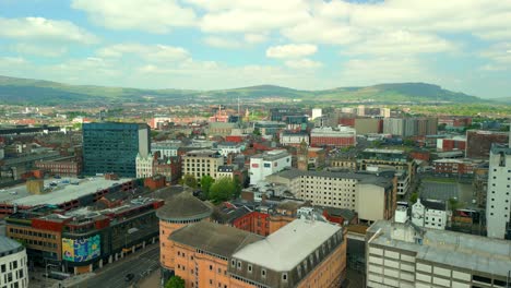 wide, reversing aerial video of belfast city centre and the surrounding area in northern ireland, uk on a bright and sunny day. filmed in 4k, 60fps and in rec709 color.