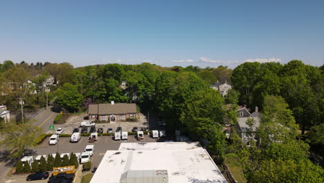 aerial lowering footage of united states post office in hingham, high elevation to low ground
