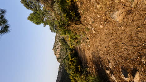 4k-Vertical-shot-of-hiking-trail-path-that-leads-to-a-mountain-cliff-at-La-Concha,-Marbella,-Spain