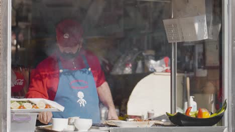 street food vendor preparing grilled fish