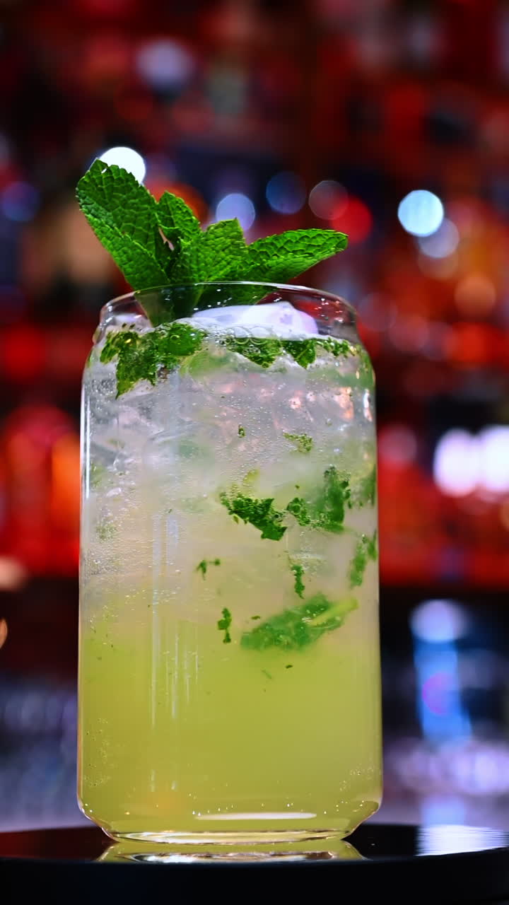 Bright mint cocktail closeup. Mint and ice blend in a vivid refreshing cocktail captured under bar lighting