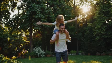 father and daughter playful fun in the garden