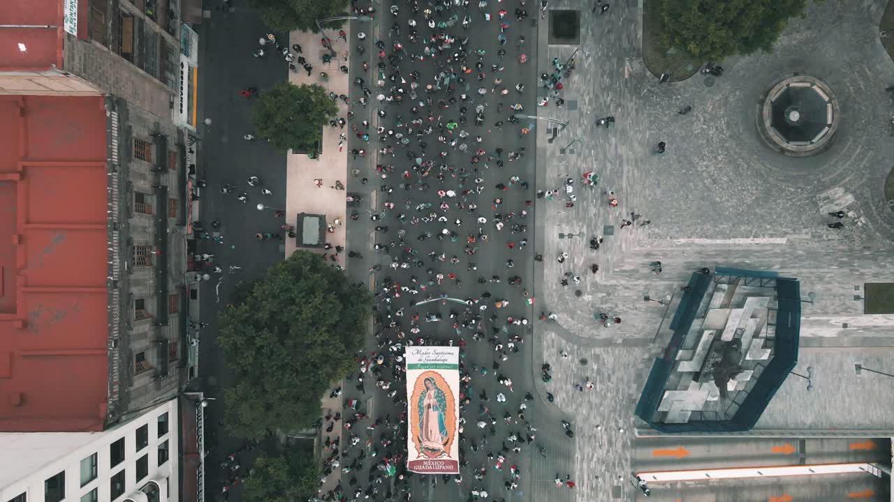 Aerial view of Virgen de Guadalupe procession in mexico city downtown protecting monuments
