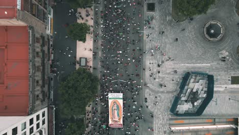 aerial view of virgen de guadalupe procession in mexico city downtown protecting monuments